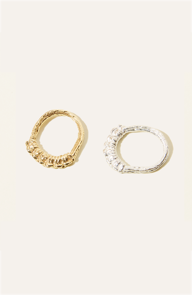 A gold and a silver ring both with interesting thread like textures