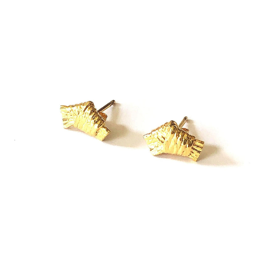 Tiny bows constructed in cotton and cast in metals. 