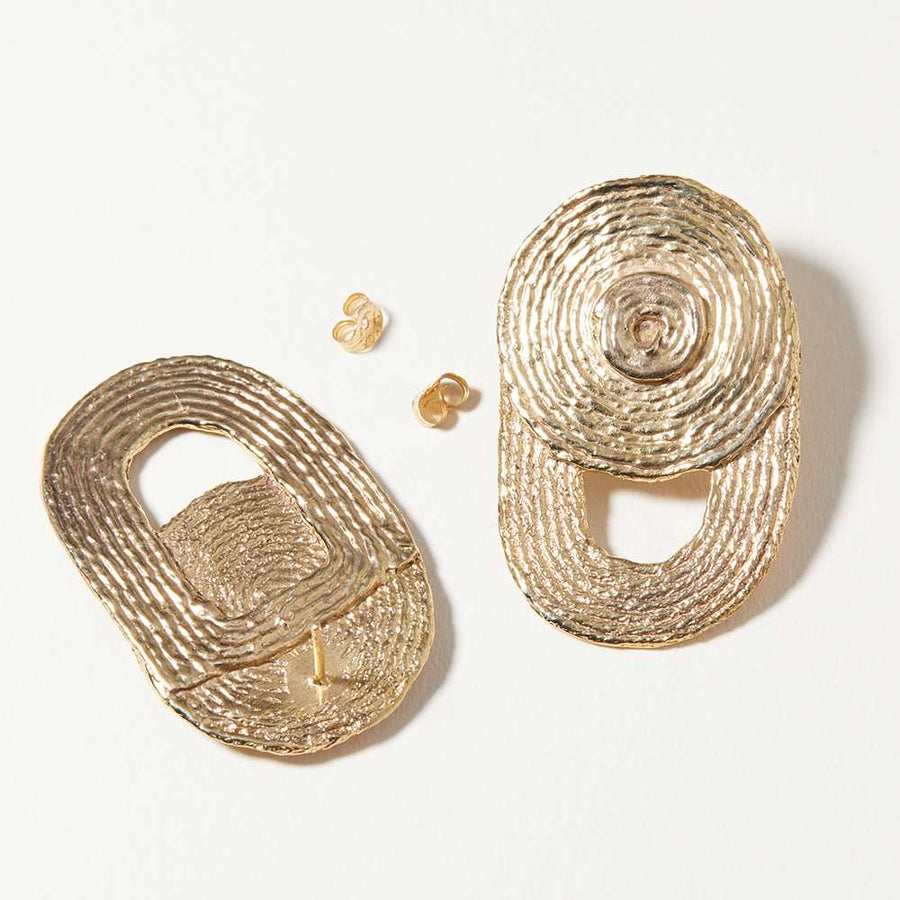The circular and textural quality of these statement earrings resemble the thread that was used to compose the forms. Large circles are cradled with arcs and an opening. 