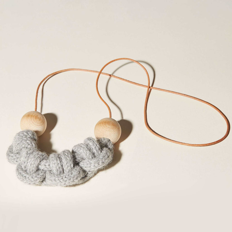This macramé inspired, knotted necklace is made of all soft materials. Round cut leather cord, 2 natural wooden beads and baby alpaca make natural material based piece of jewelry