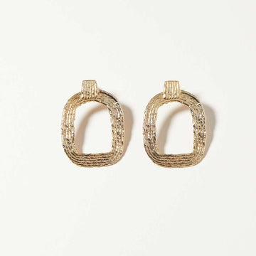 Eva Hoops earrings from COG hang from the ear as a rounded rectangle and square detail. Macramé inspired as a homage to artist Bridget Riley.
