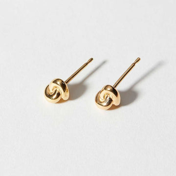 The Knot Studs were formed by hand in clay and cast in 14k gold plated reclaimed brass. 