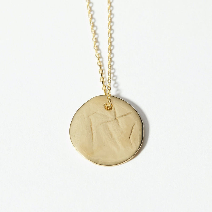 The Lunar pendant was handmade in clay and cast in 14k gold plate. Slightly textured surface and bright finish.