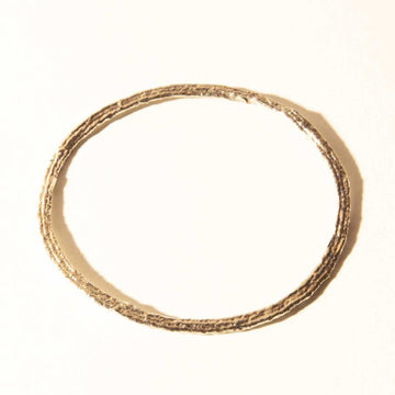 Strands of cotton thread were formed into a sphere to create this textural bracelet by COG.