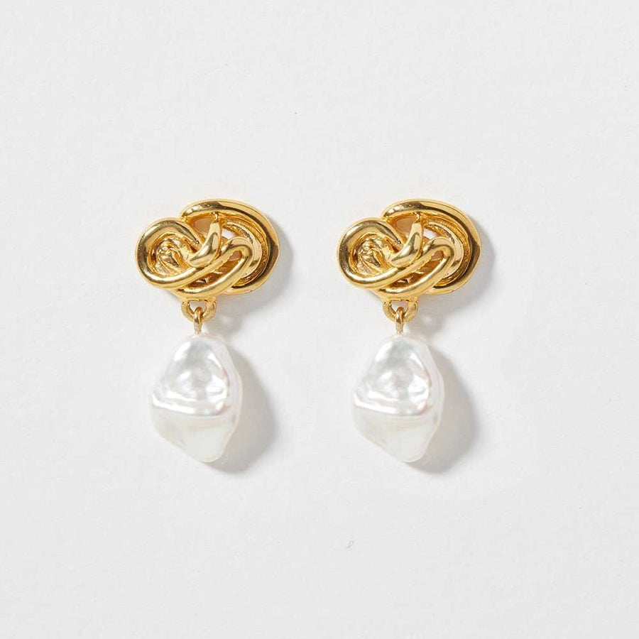 The Tempest Earrings are organically shaped earring paired with a iridescent fresh water pearl.