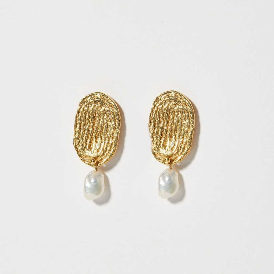 A thumprint-like pattern has been made from composing cotton thread into a spiraled pattern. An 1/8 inch fresh water pearl hangs delicately rom the bottom edge of each earring.
