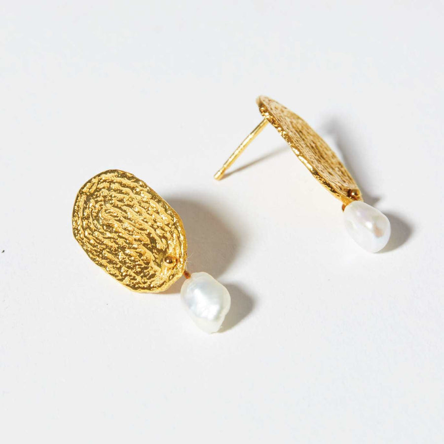The Thumbprint Earrings from COG are textured drop earrings that combine a tiny, fresh water pearl.