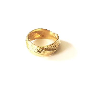 A banded, woven ring with a continuous braid. Cast in 14K Plated Gold or sterling silver.